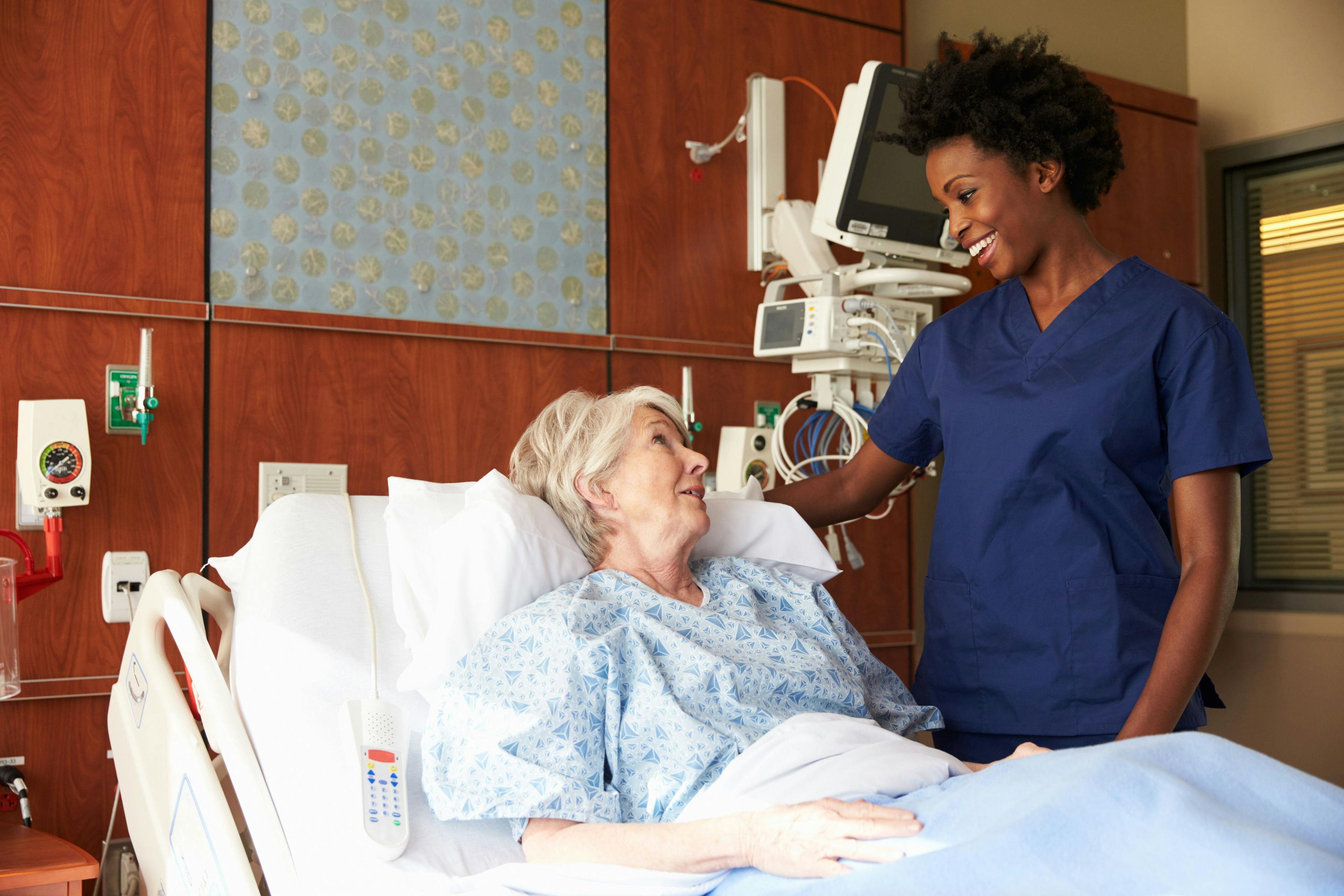 doctor talking to an elderly woman in a hospital bed