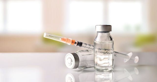 Vials and Syringe on White Table with Background Windows Stock Photo | © iStockPhoto.com