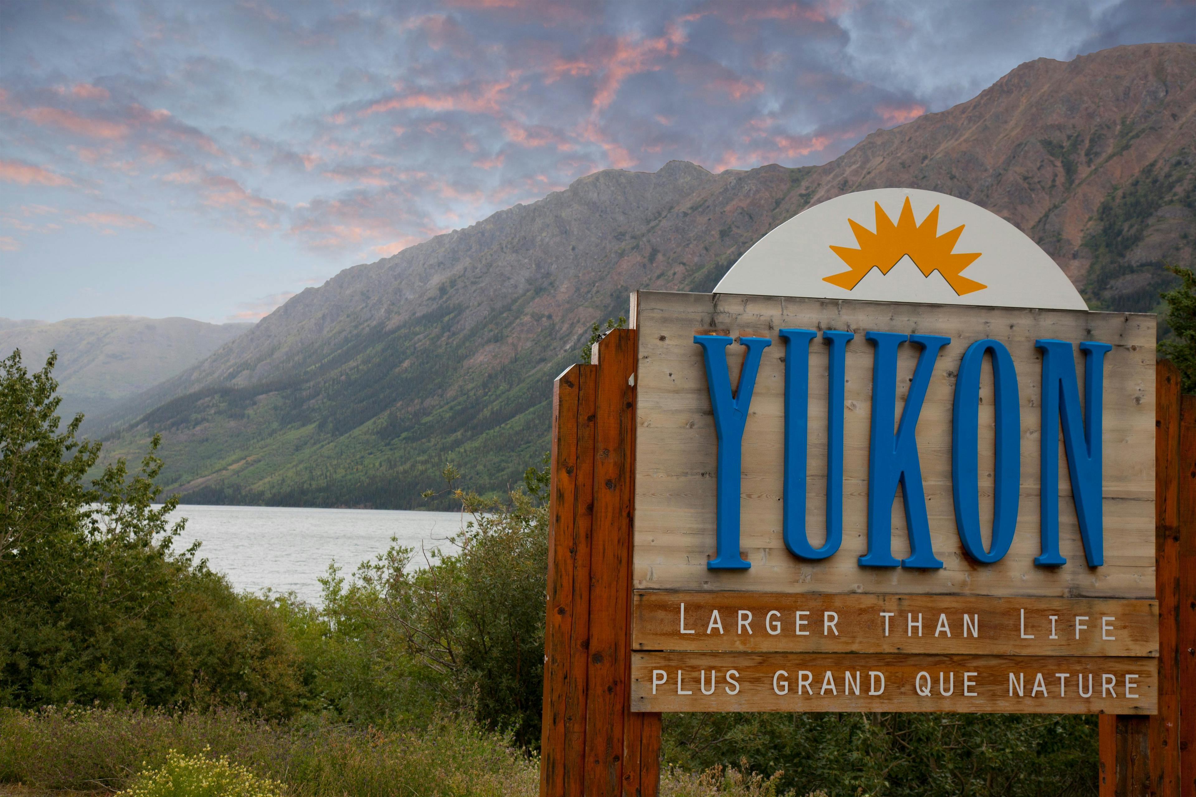 Mountains with sign saying Yukon Larger Than Life Plus Grand Que Nature | Image credit: nickjene - stock.adobe.com.