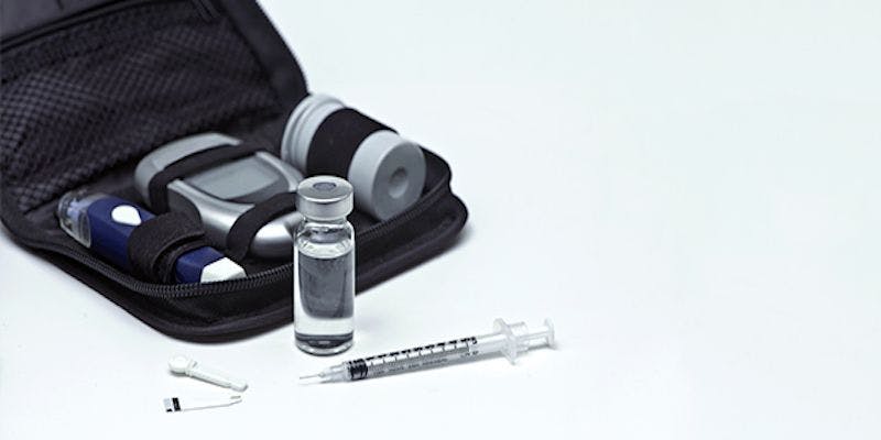 image of kit including insulin, needle, glucose monitor, and blood sugar test strips