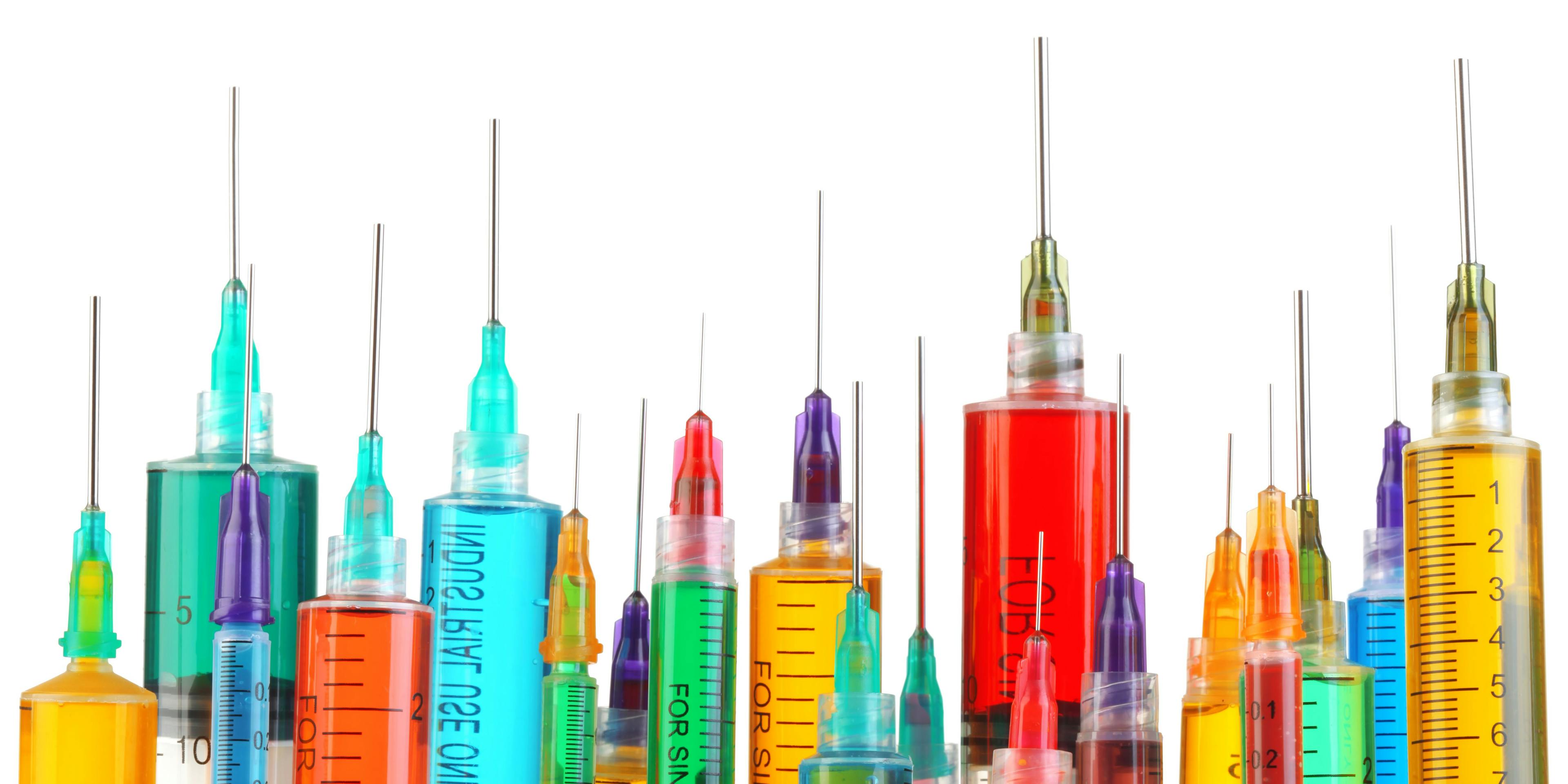 several syringes filled of all sized filled with different color liquids 