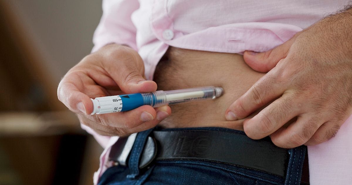 man administering medicines with autoinjector pen | Image credit: RFBSIP - stock.adobe.com.