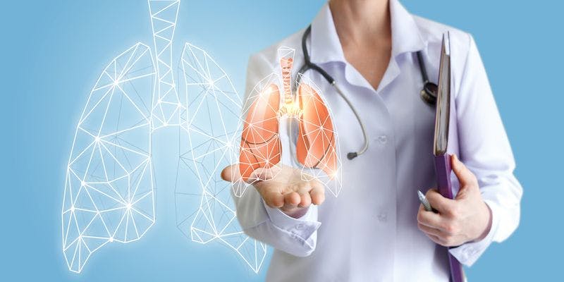 doctor holding computerized image of lungs