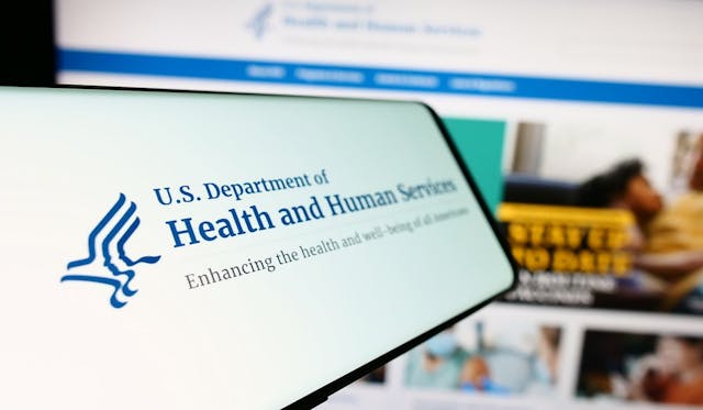 HHS on a phone | Image credit: Timon - stock.adobe.com