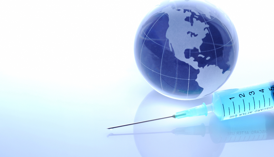 syringe sitting in front of a globe displaying the Americas