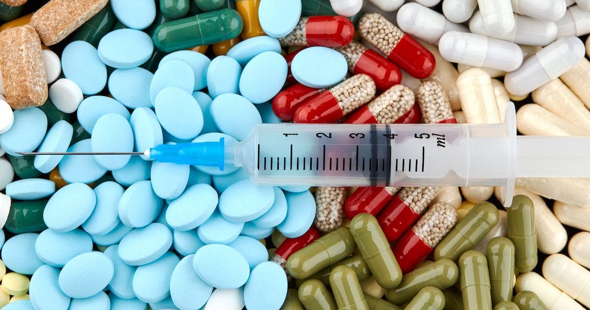 syringe over pill pile
