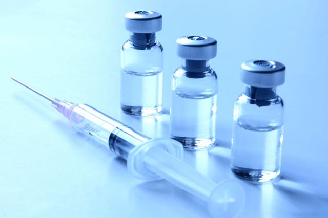 e vials filled with clear liquid and a syringe