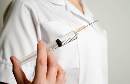 doctor holding full syringe